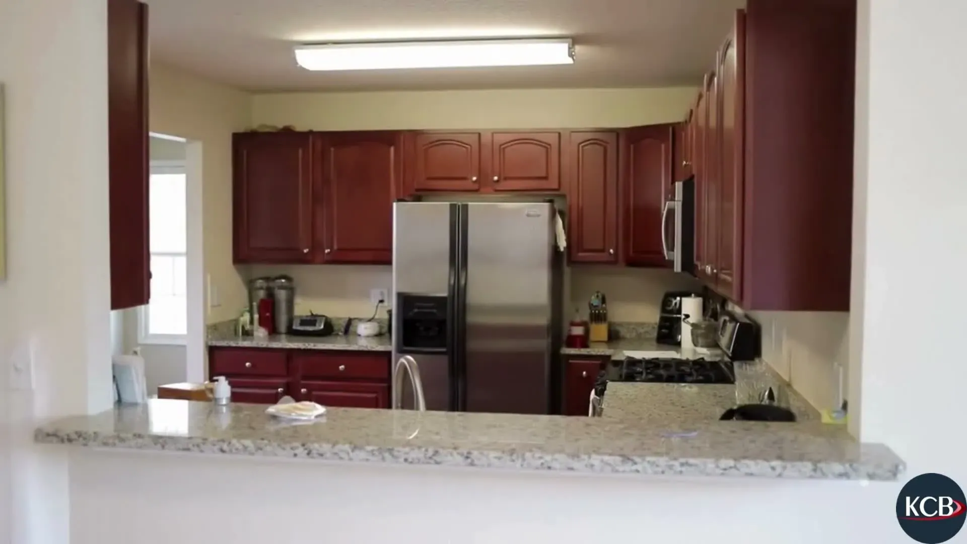 Remodeled Anaheim kitchen with a large island, painted shaker cabinetry and quartz countertops
