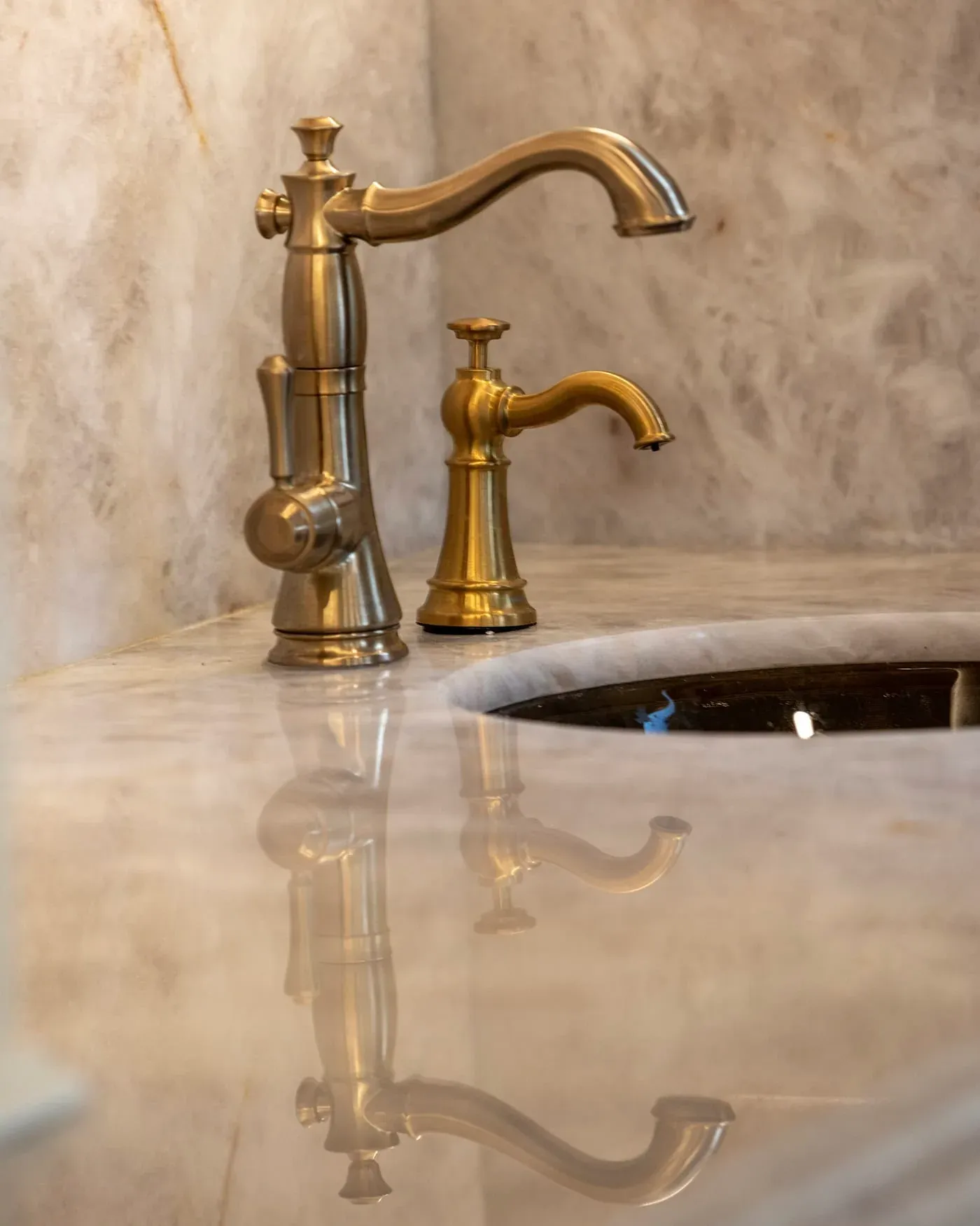 Brass tap and undermount sink in a polished onyx worktop