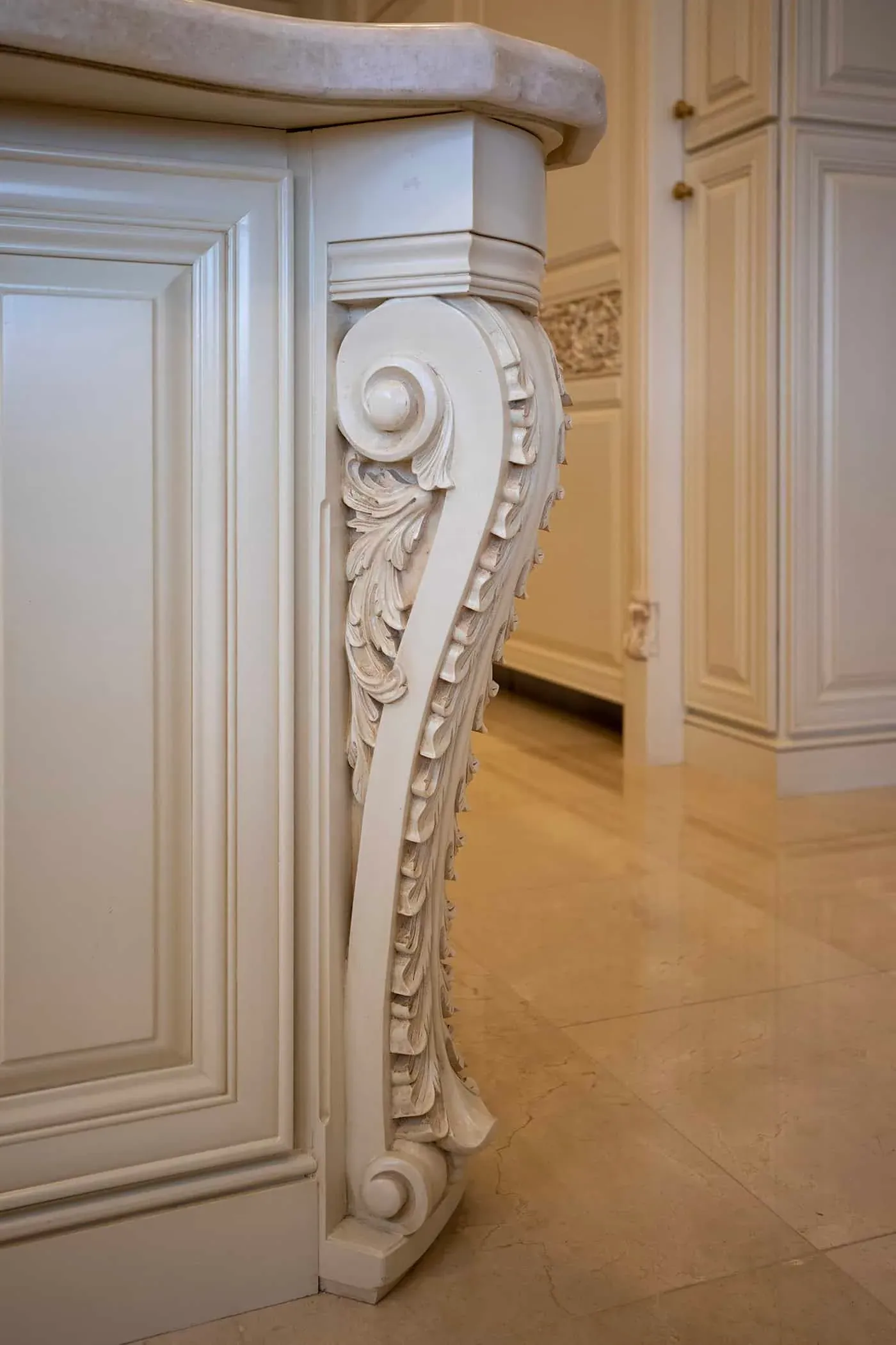 Carved acanthus corbel on a cream island end panel