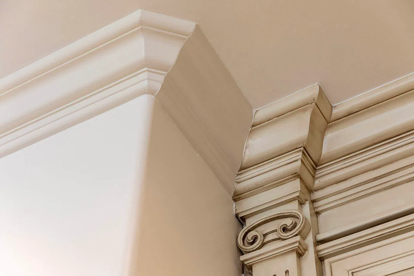 Carved crown moulding detail against a white ceiling