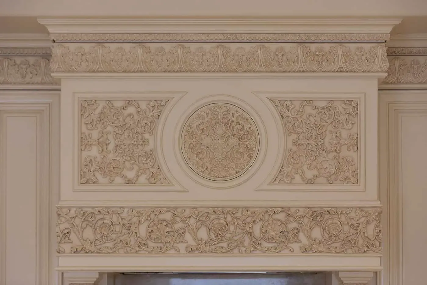 Carved overmantel panel with a central medallion