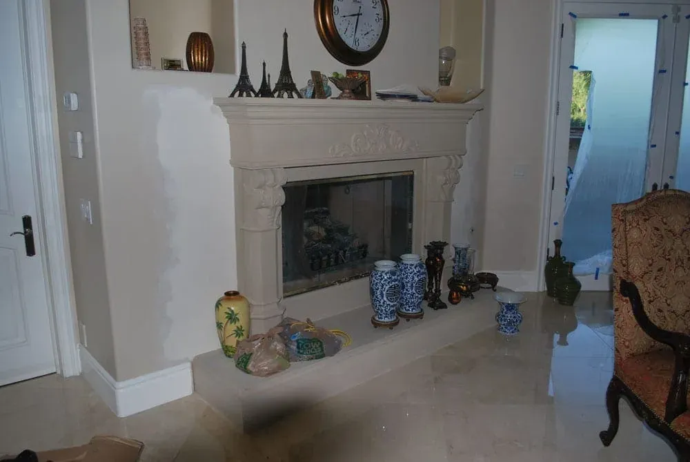Carved stone fireplace with decorative vases