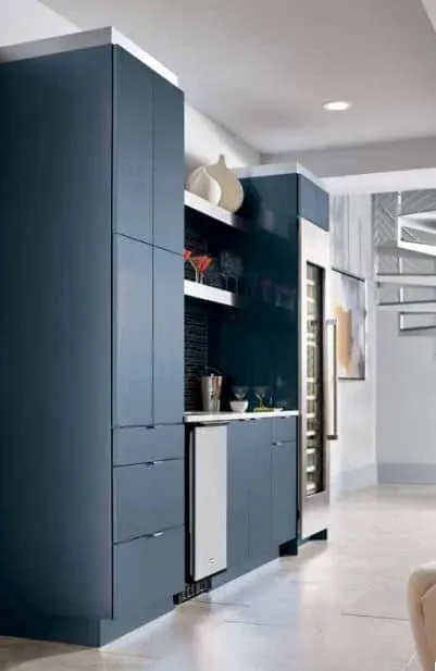 Deep navy tall cabinetry with open shelving, a wine cooler and a bar area