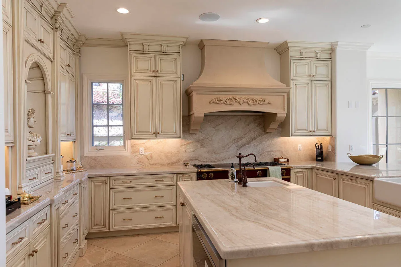 Kitchen island with a bronze bridge tap and a quartzite worktop