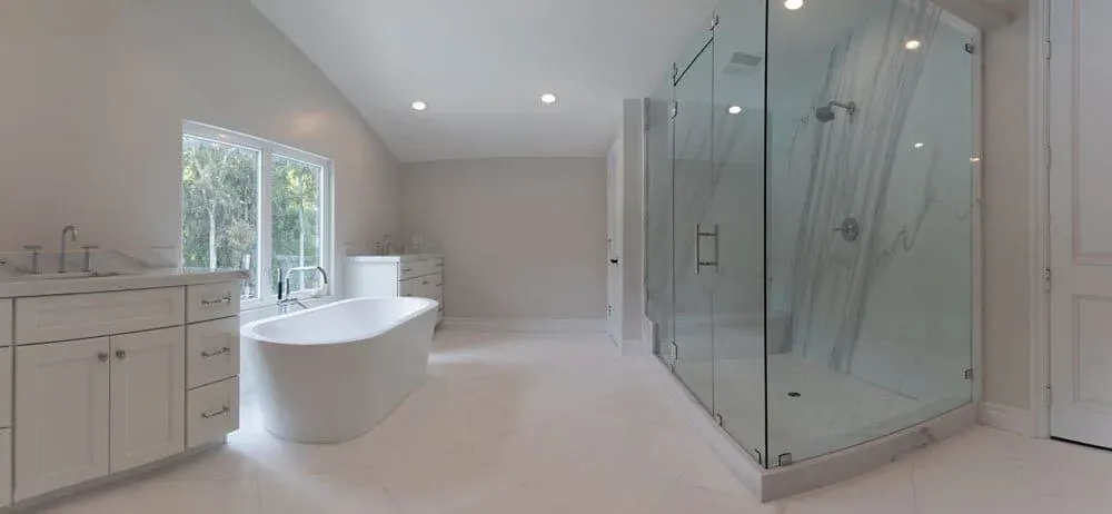 Marble bathroom with a freestanding tub and glass shower