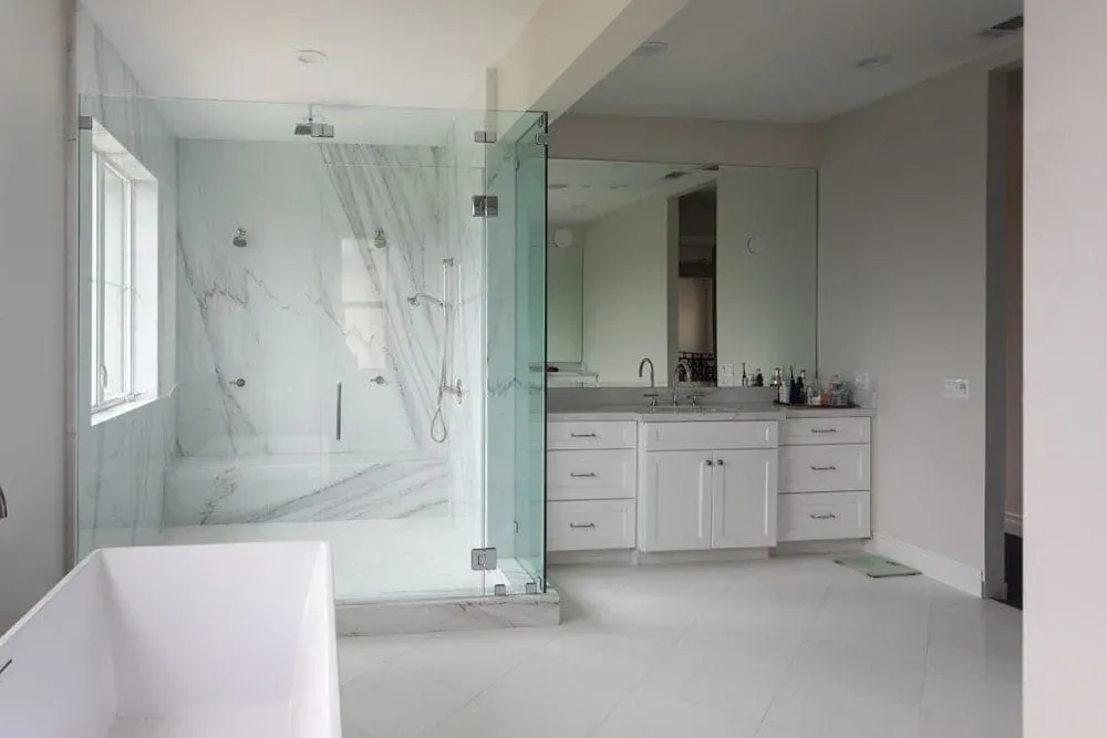 Marble shower beside a white vanity run