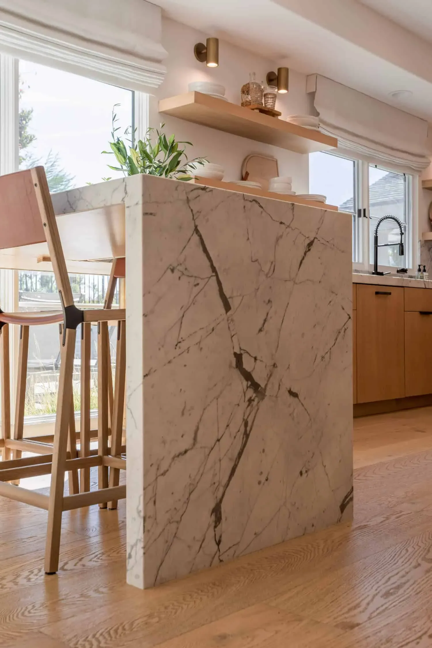 Marble waterfall island edge meeting oak cabinetry