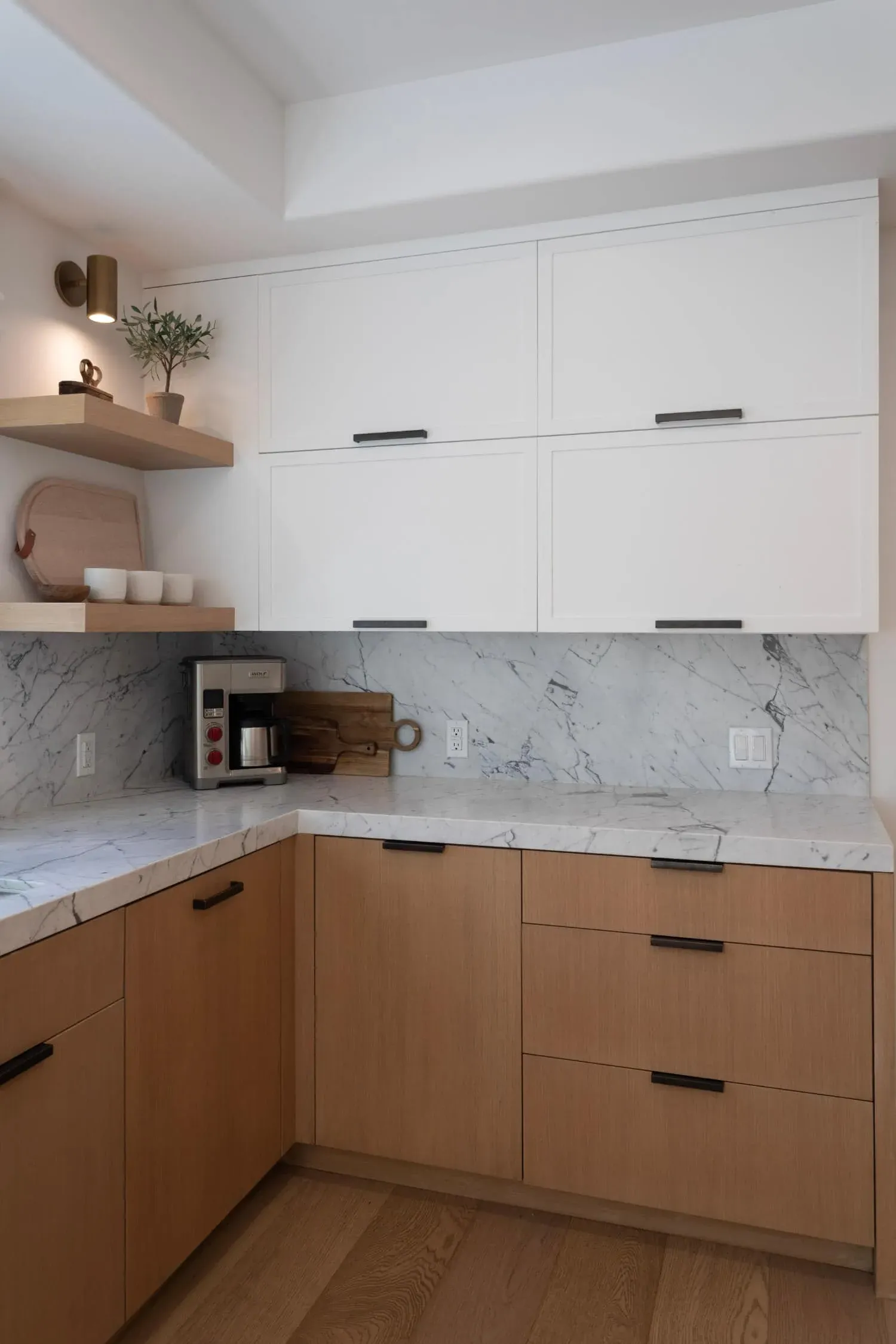 Oak base cabinets with a marble worktop and open shelving above