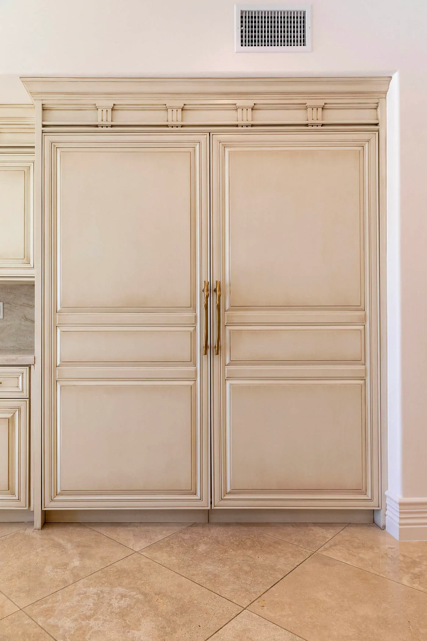 Panelled cream cabinet doors with brass hardware