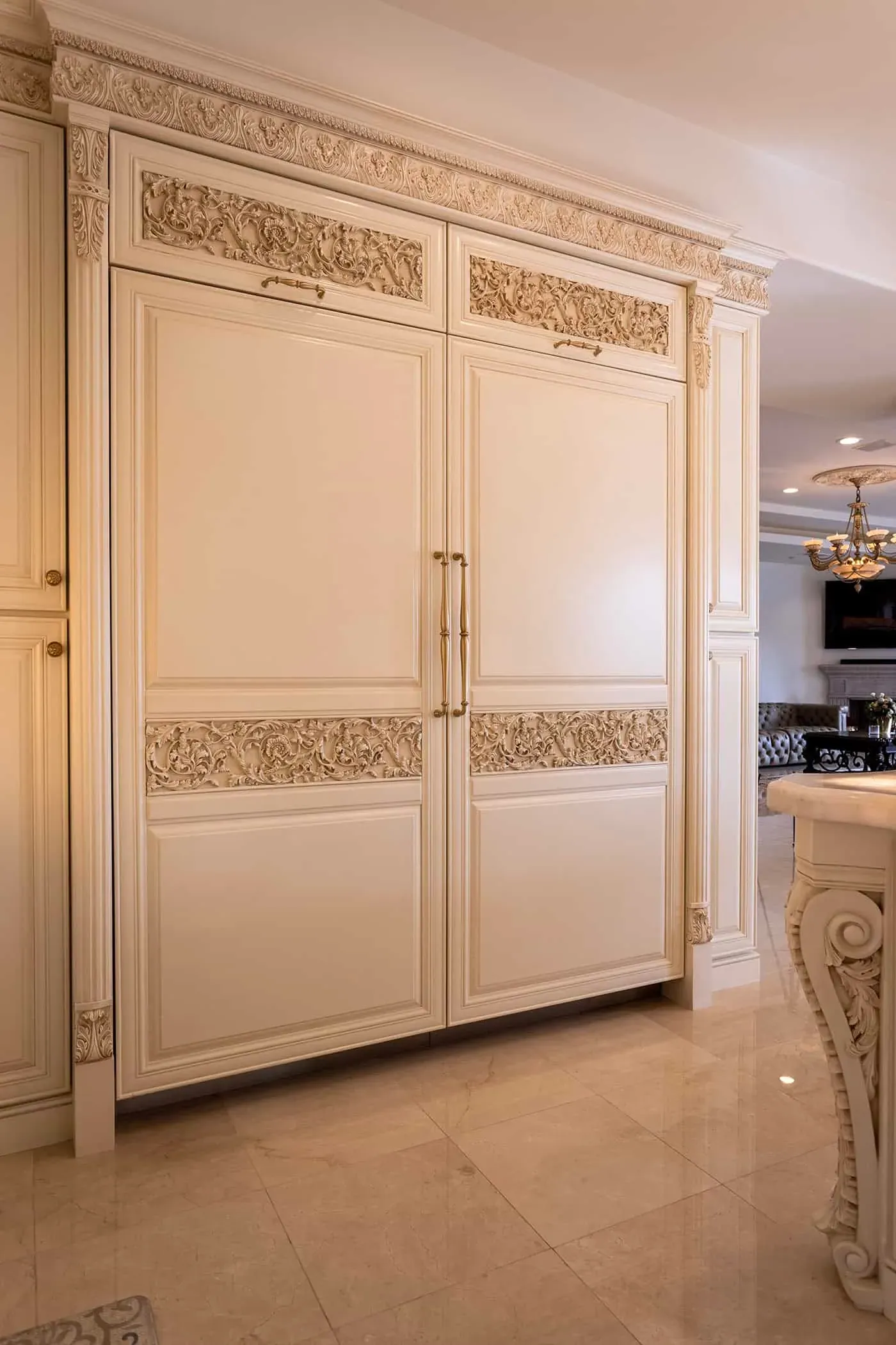 Panelled cream refrigerator with a carved frieze panel