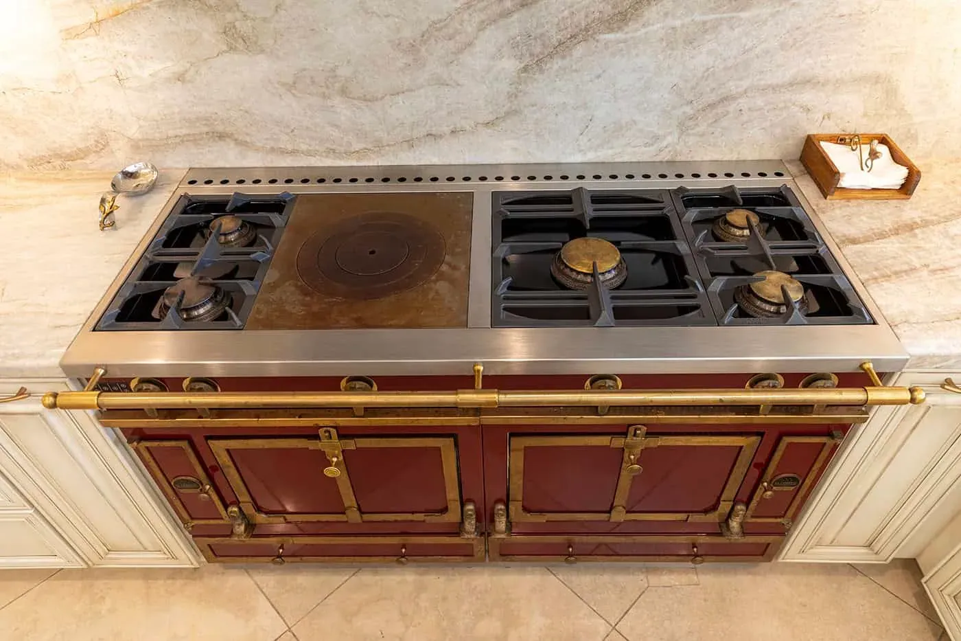 Red professional range with brass trim viewed from above
