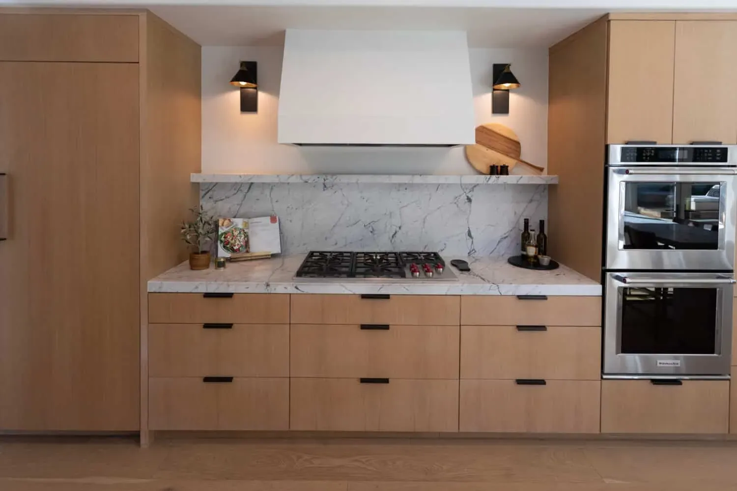 Kitchen with refaced cabinet doors and new drawer fronts above a tiled backsplash