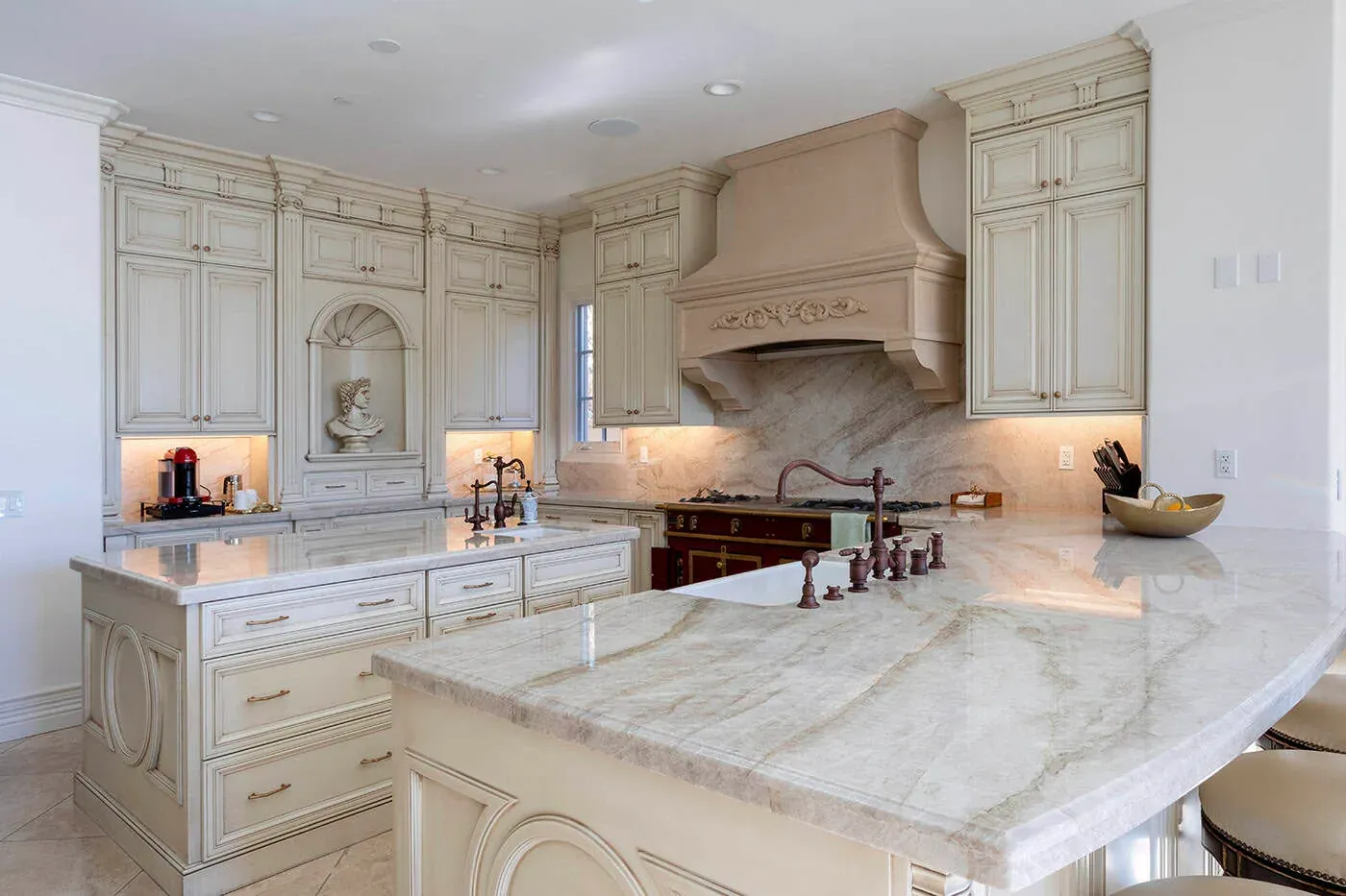 Traditional cream kitchen with an arched niche, island and bronze tap