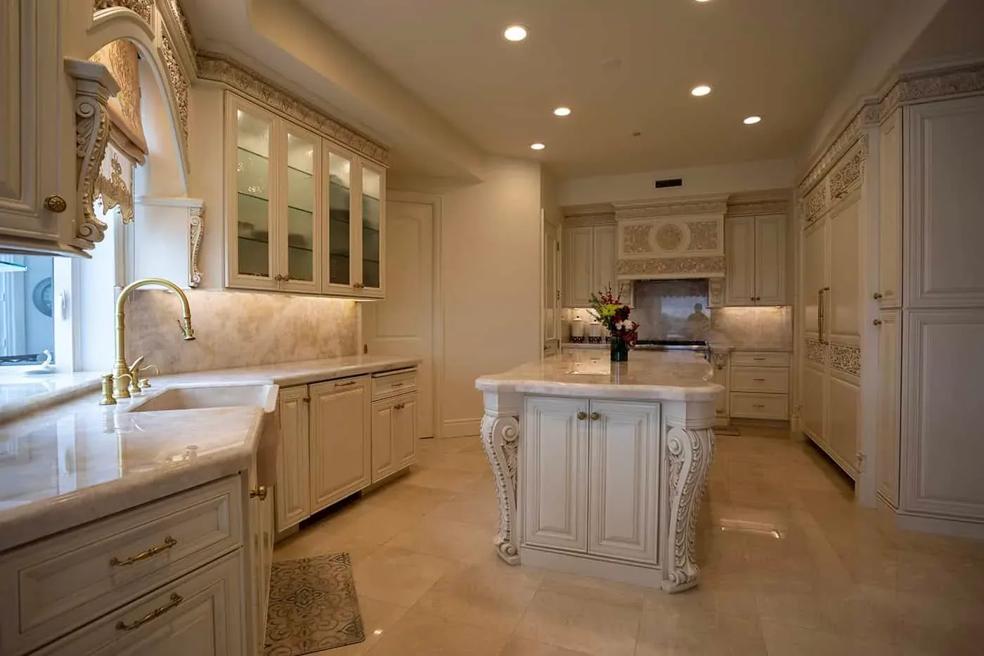 Large-format tile flooring laid through a traditional Orange County kitchen with a corbel-legged island
